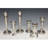 A pair of silver candlesticks with tapering stems and circular bases, Birmingham 1957, a silver