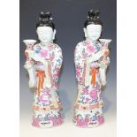 A pair of Chinese famille rose porcelain figures of maidens, 20th Century, each modelled standing