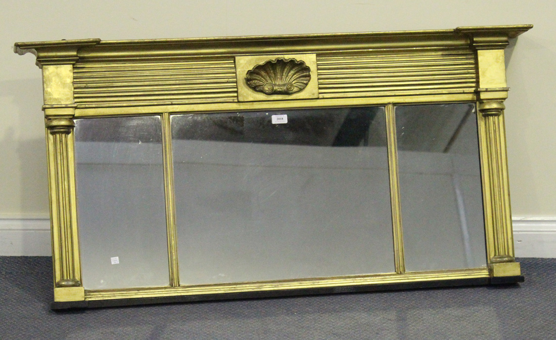 A Regency giltwood overmantel mirror, the reeded freeze and shell mount above a triple section