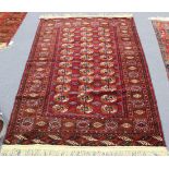 A Turkestan rug, late 20th Century, the dark claret field with three columns of twelve guls,