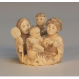 A Japanese carved ivory okimono figure group, Meiji/Taisho period, carved in the round with two