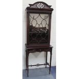 An Edwardian Chinese Chippendale style mahogany display cabinet-on-stand, with fretwork and blind