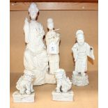 A group of four Chinese blanc-de-Chine figures, comprising a seated dignitary and attendant,