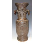 A Japanese brown patinated bronze vase, Meiji period, the flared neck cast with prunus on a wave