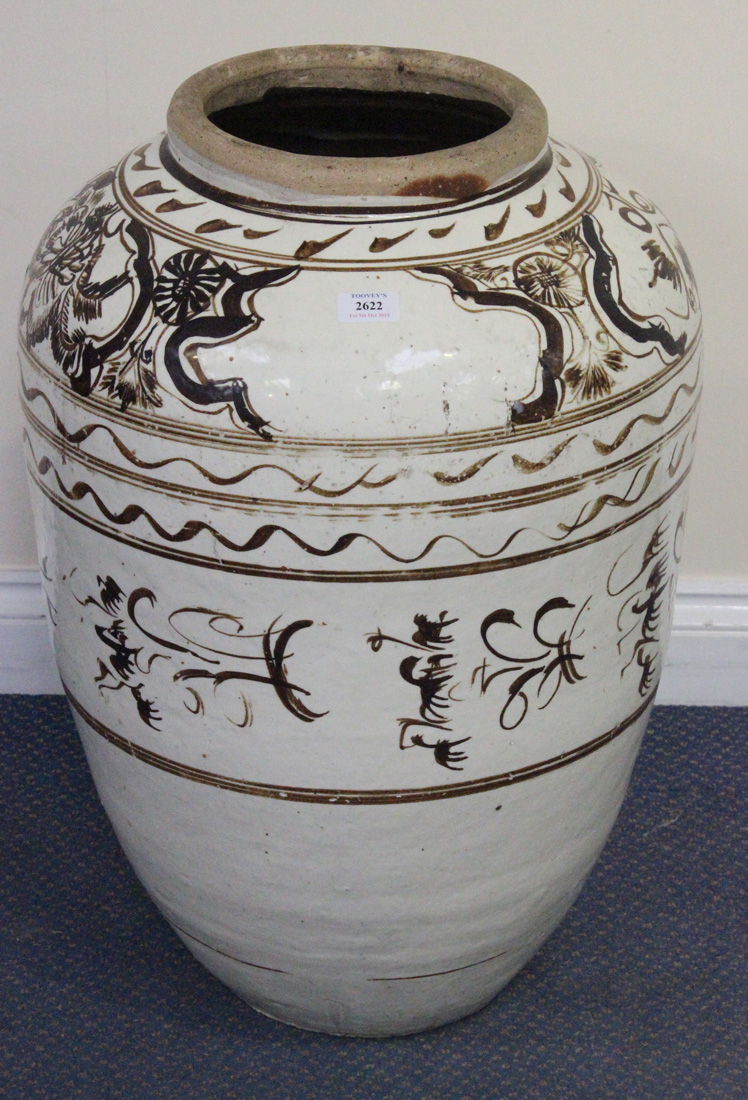 A modern South-east Asian Cizhou style ovoid floor vase, the cream glazed body decorated in brown,
