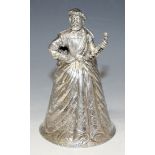 A late Victorian silver figural desk bell, in the form of a bearded gentleman wearing Tudor costume,