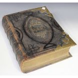 A 19th Century leather bound and brass mounted Holy Bible, length approx 33cm.
