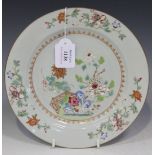 A Chinese famille rose export porcelain plate, Qianlong period, painted with a fenced peony garden