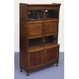 An early 20th Century oak Minty four-section glazed bookcase, fitted with four glazed doors, a