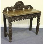 A late Victorian oak hall table, profusely carved with scrolls and masks, on tapering legs, height