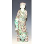 A Chinese famille verte enamelled biscuit porcelain figure of Li Tieguai (Iron-Crutch Li), Kangxi