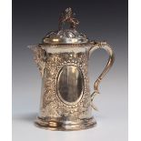A large Victorian silver tankard, the domed hinge lid with rampant lion and pierced monogram finial,