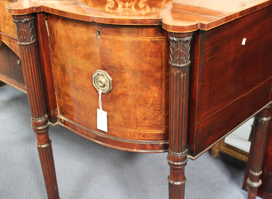 A George III figured mahogany and rosewood crossbanded sideboard, the shaped top with four - Image 2 of 4