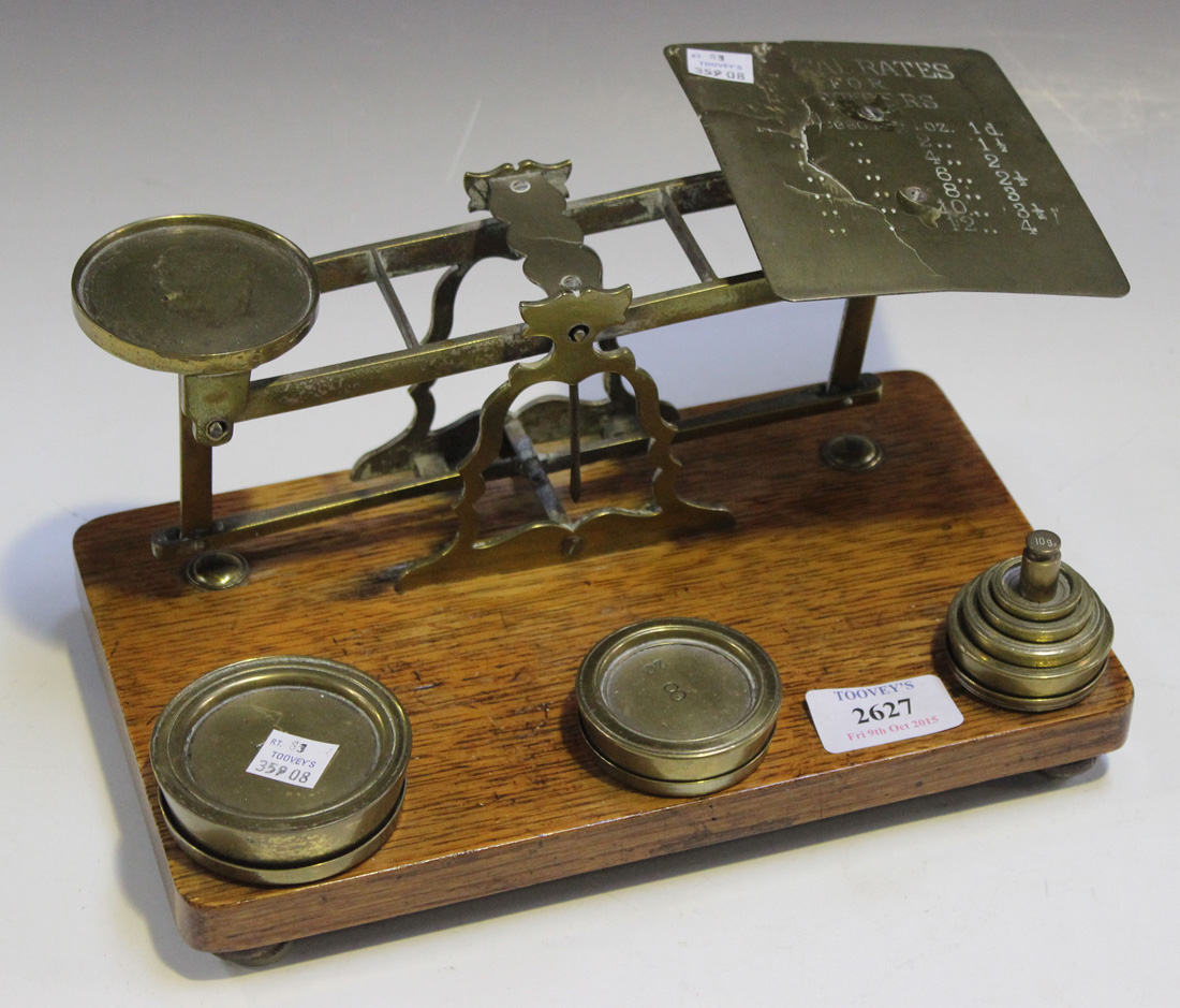 A Victorian set of postal scales and weights on an oak pedestal base, width approx 25.4cm (faults).