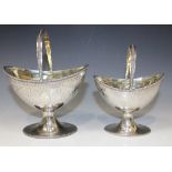 A pair of George III silver graduated bonbon baskets, each of oval form with a later beaded swing