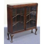 A George V mahogany bookcase, fitted with a pair of astragal glazed doors revealing two adjustable