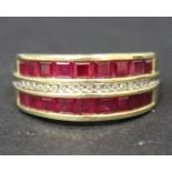 A 9ct gold ruby and diamond set ring, mounted with a row of small circular cut diamonds between