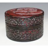 A red and black lacquer cylindrical box and cover, probably 20th Century, the top decorated in
