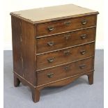 A George III mahogany chest with crossbanded borders, fitted with four long drawers above a shaped