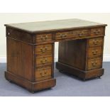 A late Victorian oak twin pedestal desk, the moulded top inset with green leather above an