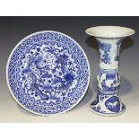 A Chinese blue and white porcelain plate, late 19th Century, painted with dragons amidst peony