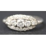 A platinum and diamond ring, claw set with the three principle circular cut diamonds within an