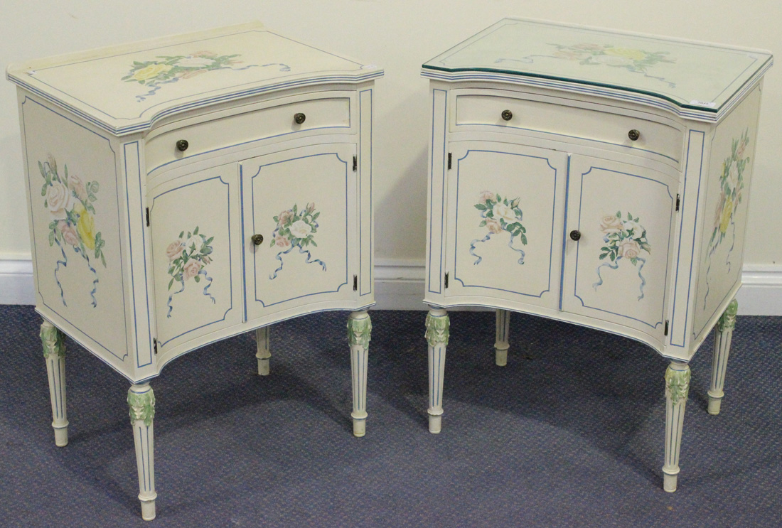 A pair of 20th Century white and floral painted bedside cabinets, both fitted with a drawer above