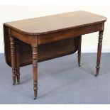 A Victorian mahogany drop-flap side table, raised on turned legs with brass caps and castors,