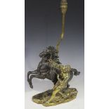 After Guillaume Cousteau - a 20th Century brown patinated and gilt cast bronze figure group of a