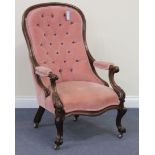 A mid-Victorian mahogany showframe salon armchair, upholstered in buttoned pink velour, the open