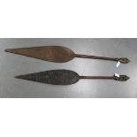 A pair of 20th Century African tribal spears of paddle form with carved shaped leaf ends, rounded