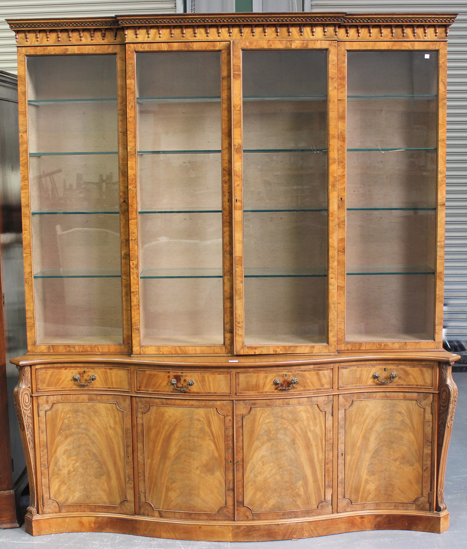 A 20th Century George III style flame mahogany and yew bookcase cabinet, the breakfront top with a