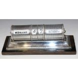 A George V silver desk calendar of cylindrical form with engine turned decoration, on a