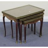 A 20th Century French style mahogany nest of three occasional tables, with pierced brass