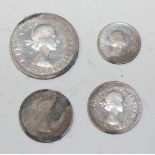 A group of Elizabeth II Maundy coinage, comprising a fourpence, two twopences and a penny.