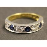 An 18ct gold, sapphire and diamond set seven stone half hoop eternity ring, mounted with four