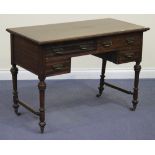 An Edwardian walnut desk fitted with four drawers, raised on turned legs united by stretchers, width