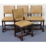 A set of four 20th Century Carolean Revival oak dining chairs with upholstered leather seats and