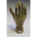 An early 20th Century wooden artist's model of a hand with articulated fingers and wrist, length