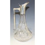 A late Victorian silver mounted cut glass claret jug, the silver spout and collar with hinged tappit