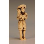 A Japanese carved ivory okimono netsuke, probably 19th Century, modelled as a standing European