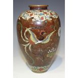 A Japanese cloisonné vase, Meiji period, the ovoid body decorated with two ho-o birds and flowers on