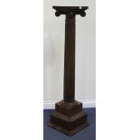An early 20th Century walnut jardinière pedestal, the carved Ionic capital above a fluted stem and