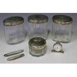 A group of four silver and cut glass toilet jars, two silver and mother-of-pearl folding fruit