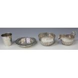 An Edwardian silver cream jug and sugar bowl with half reeded decoration, Sheffield 1907 by James