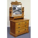 An Edwardian satin walnut dressing chest, the swing frame mirror above two short and two long