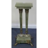 An early 20th Century green onyx and champlevé enamelled stand with overall gilt metal mounts, the