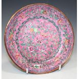 A Chinese Canton export enamel saucer dish, 18th Century, painted with a dense design of
