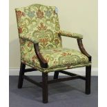 A 20th Century George III style elbow chair, upholstered in a patterned damask, on moulded block