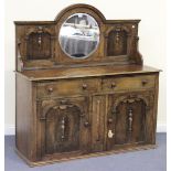 A George V oak mirrored back sideboard with applied mouldings, the base fitted with two drawers